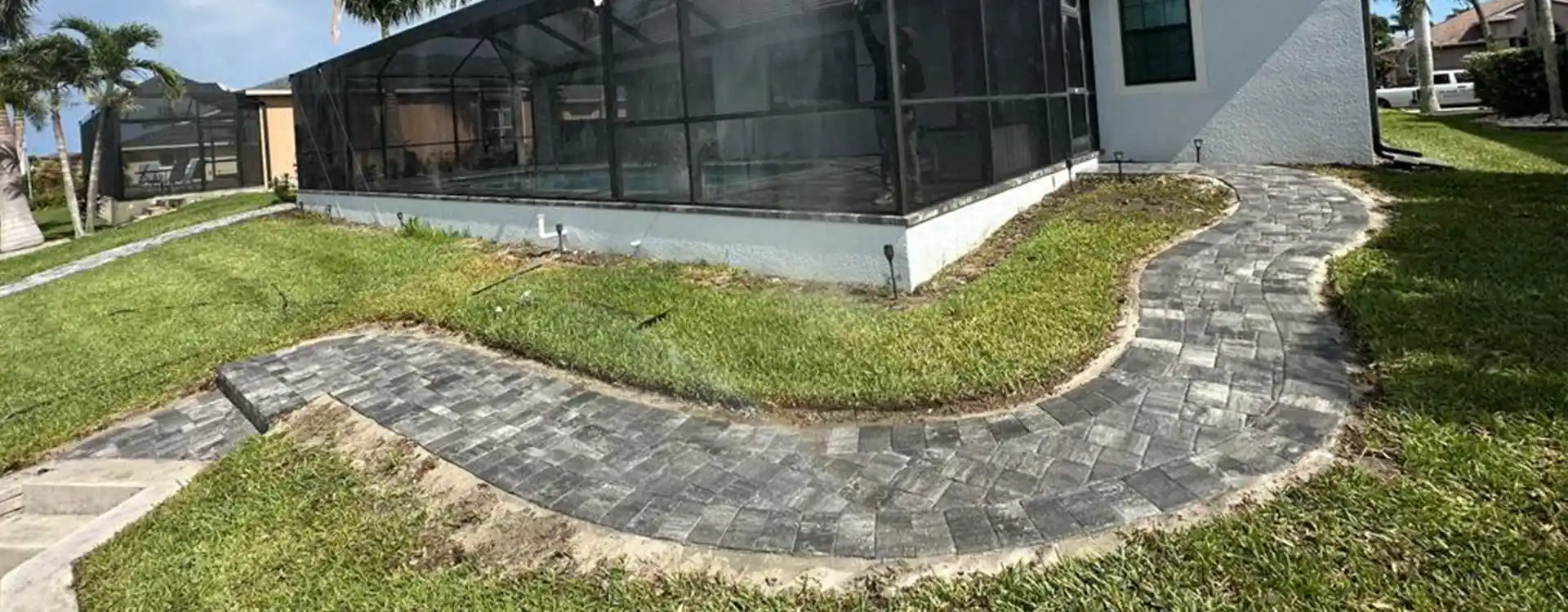 Curved paver walkway through a backyard lawn